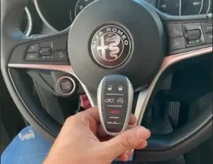 Professional Alfa Romeo car locksmith in Miami programming a luxury smart key.