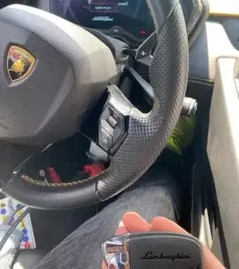 Professional Lamborghini car locksmith in Miami programming a luxury smart key fob.